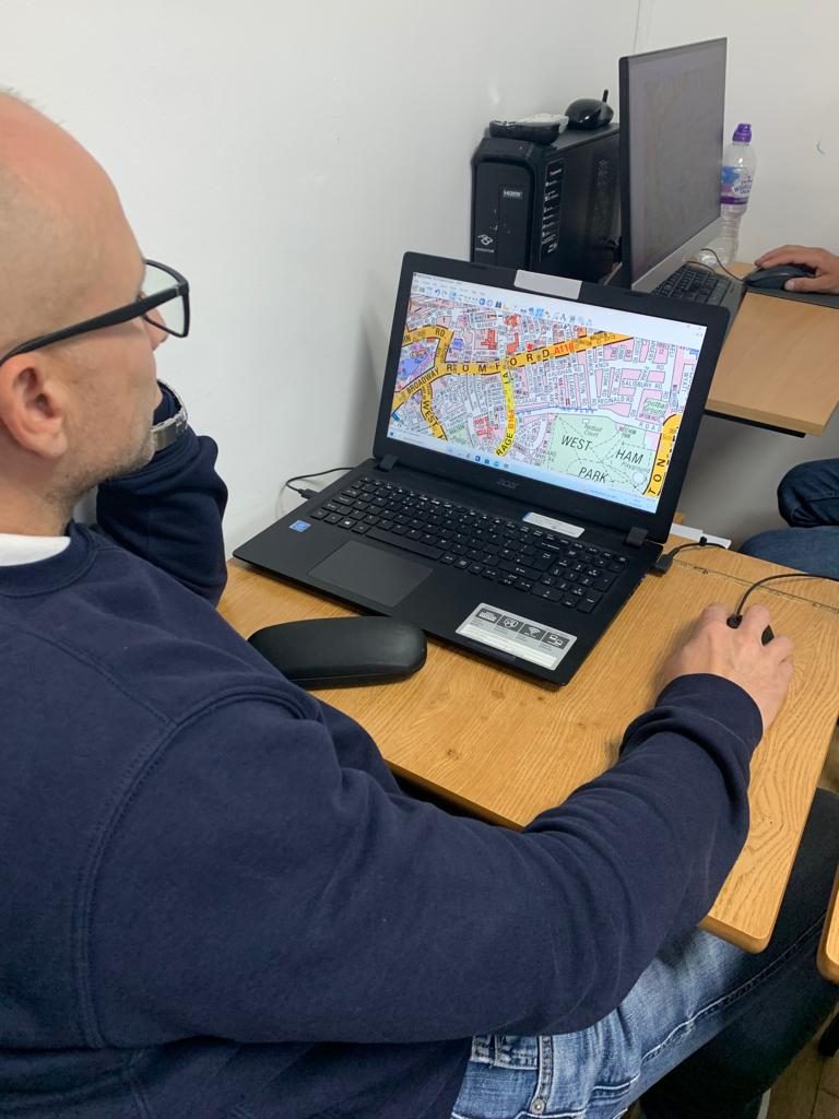 A driver planning a route on screen during topographical skills training
